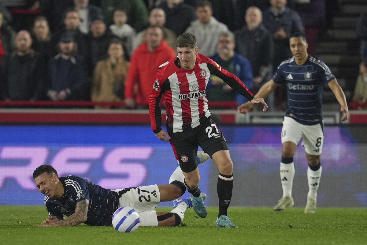 Aston Villa's Morgan Rogers falls following a challenge from Brentford's Vitaly Janelt during the English Premier League soccer match between Brentford and Aston Villa at the Gtech Community stadium in London, Saturday, March 8, 2025. (AP Photo/Kin Cheung)