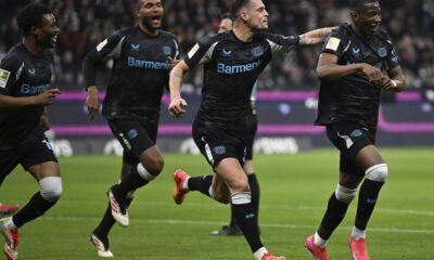 Leverkusen's scorer Nordi Mukiele, right, and his teammates celebrate their side's second goal during the German Bundesliga soccer match between Eintracht Frankfurt and Bayer Leverkusen in Frankfurt, Germany, Saturday, March 1, 2025. (Arne Dedert/dpa via AP)