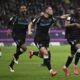 Leverkusen's scorer Nordi Mukiele, right, and his teammates celebrate their side's second goal during the German Bundesliga soccer match between Eintracht Frankfurt and Bayer Leverkusen in Frankfurt, Germany, Saturday, March 1, 2025. (Arne Dedert/dpa via AP)