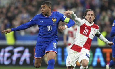 Croatia's Luka Modric, right, and France's Kylian Mbappe compete for the ball during the UEFA Nations League quarterfinal second leg soccer match between France and Croatia, at the Stade de France in Saint-Denis, outside Paris, Sunday, March 23, 2025. (AP Photo/Thibault Camus)