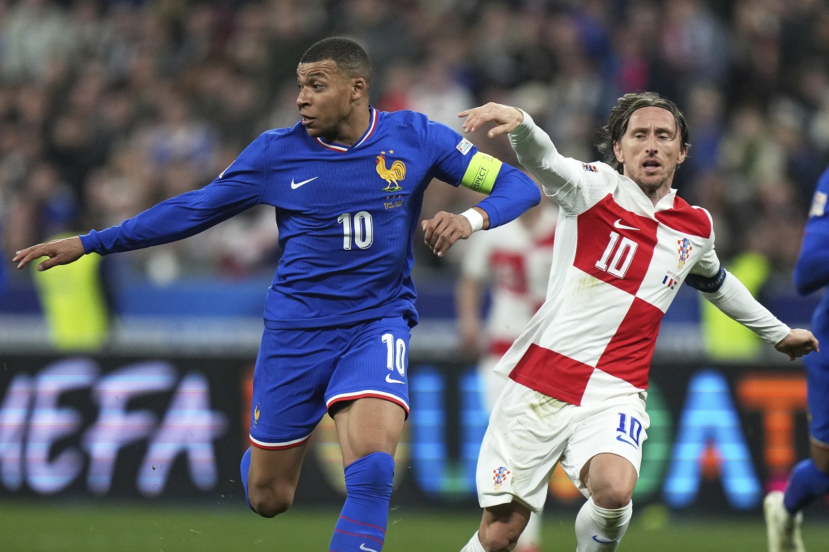 Croatia's Luka Modric, right, and France's Kylian Mbappe compete for the ball during the UEFA Nations League quarterfinal second leg soccer match between France and Croatia, at the Stade de France in Saint-Denis, outside Paris, Sunday, March 23, 2025. (AP Photo/Thibault Camus)