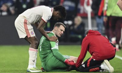 Munich's goalkeeper Manuel Neuer, center, receives treatment during the Champions League round of 16 first leg soccer match between FC Bayern Munich and Bayer 04 Leverkusen in Munich, Germany, Wednesday, March 5, 2025. (Sven Hoppe/dpa via AP)