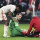 Munich's goalkeeper Manuel Neuer, center, receives treatment during the Champions League round of 16 first leg soccer match between FC Bayern Munich and Bayer 04 Leverkusen in Munich, Germany, Wednesday, March 5, 2025. (Sven Hoppe/dpa via AP)