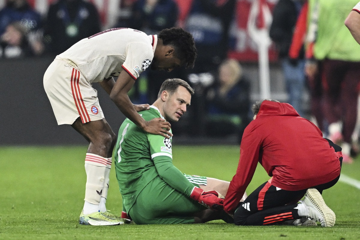 Munich's goalkeeper Manuel Neuer, center, receives treatment during the Champions League round of 16 first leg soccer match between FC Bayern Munich and Bayer 04 Leverkusen in Munich, Germany, Wednesday, March 5, 2025. (Sven Hoppe/dpa via AP)