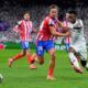 Spain Soccer Champions League Atletico Madrid's Marcos Llorente, left, fights for the ball with Real Madrid's Vinicius Junior during the Champions League round of 16 first leg soccer match between Real Madrid and Atletico Madrid at the Bernebeu stadium in Madrid, Spain, Tuesday, March 4, 2025. (AP Photo/Manu Fernandez)