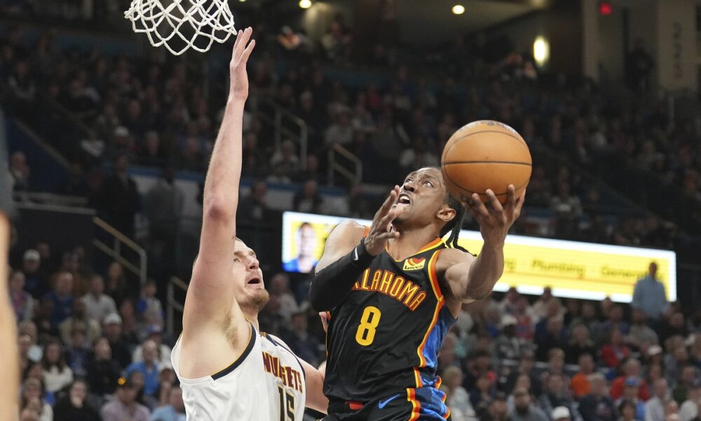 Oklahoma City Thunder forward Jalen Williams (8) shoots over Denver Nuggets center Nikola Jokic (15) during the second half of an NBA basketball game, Sunday, March 9, 2025, in Oklahoma City. (AP Photo/Kyle Phillips)