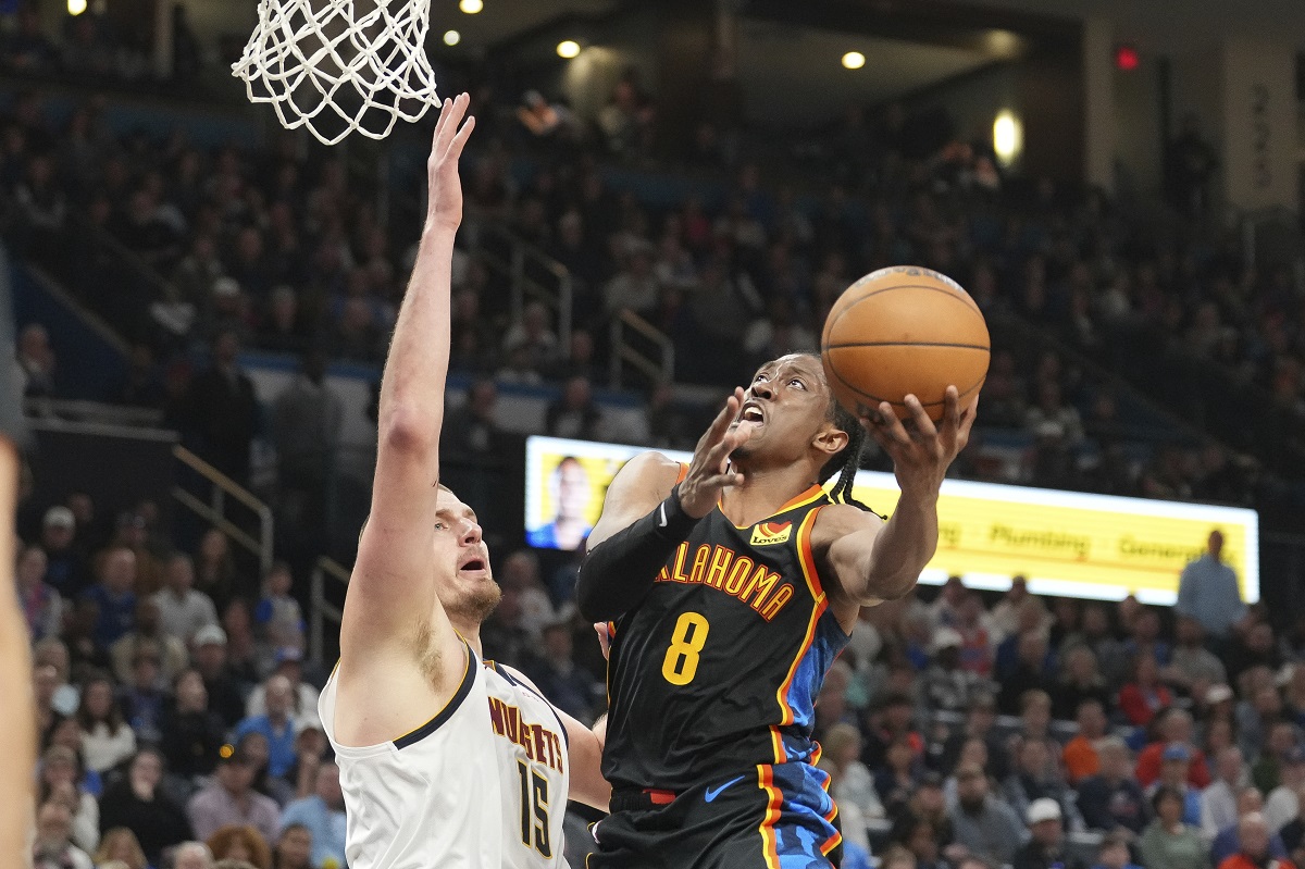 Oklahoma City Thunder forward Jalen Williams (8) shoots over Denver Nuggets center Nikola Jokic (15) during the second half of an NBA basketball game, Sunday, March 9, 2025, in Oklahoma City. (AP Photo/Kyle Phillips)