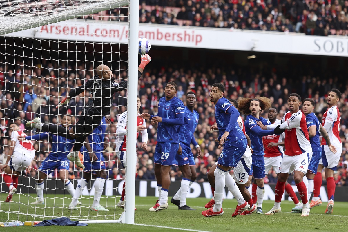 Chelsea's goalkeeper Robert Sanchez fails to save the goal from Arsenal's Mikel Merino during the English Premier League soccer match between Arsenal and Chelsea at Emirates stadium in London, Sunday, March 16, 2025. (AP Photo/Ian Walton)