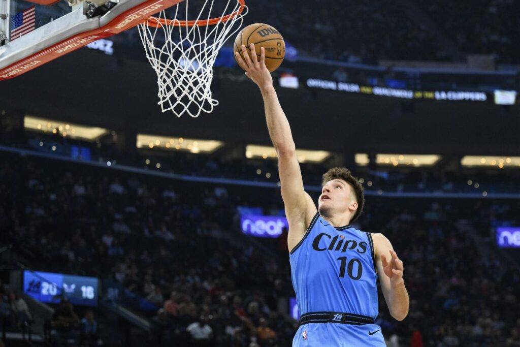 Los Angeles Clippers guard Bogdan Bogdanovic shoots during the first half of an NBA basketball game against the Charlotte Hornets, Sunday, March 16, 2025, in Inglewood, Calif. (AP Photo/William Liang)