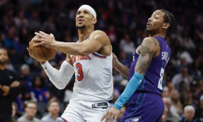 New York Knicks guard Josh Hart (3) drives to the basket against Charlotte Hornets guard Nick Smith Jr., right, during the second half of an NBA basketball game in Charlotte, N.C., Thursday, March 20, 2025. (AP Photo/Nell Redmond)