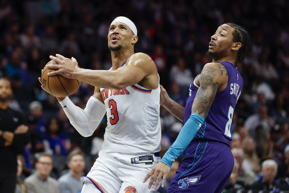 New York Knicks guard Josh Hart (3) drives to the basket against Charlotte Hornets guard Nick Smith Jr., right, during the second half of an NBA basketball game in Charlotte, N.C., Thursday, March 20, 2025. (AP Photo/Nell Redmond)