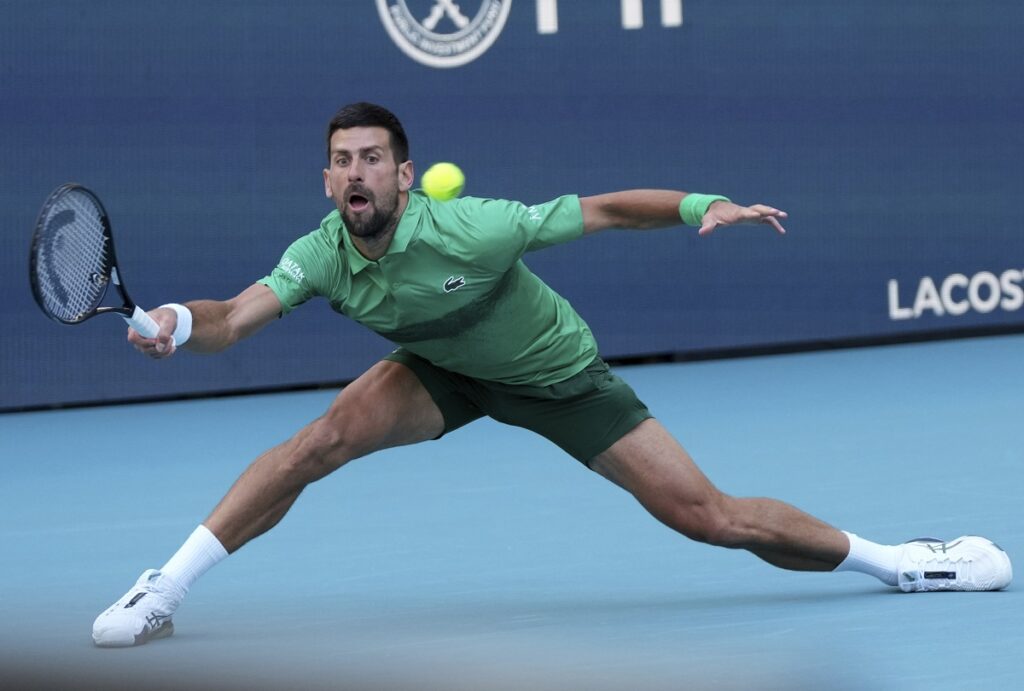 Novak Djokovic, of Serbia, hits a return to Rinky Hijikata, of Australia, during the Miami Open tennis tournament, Friday, March 21, 2025, in Miami Gardens, Fla. (AP Photo/Lynne Sladky)