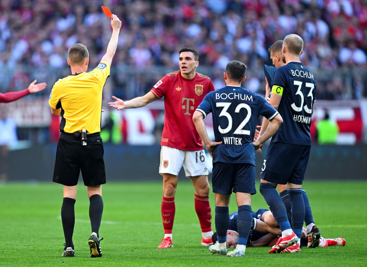 Bayern's Joao Palhinha is shown a red card by referee Christian Dingert during the German Bundesliga soccer match between Bayern Munich and VfL Bochum at the Allianz Arena in Munich, Germany, Saturday, March 8, 2025. (Sven Hoppe/dpa via AP)