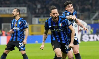 Inter Milan's Hakan Calhanoglu, centre, celebrates after scoring his side's second goal during the Serie A soccer match between Inter Milan and Monza at the San Siro stadium in Milan, Italy, Saturday, March 8, 2025. (AP Photo/Luca Bruno)