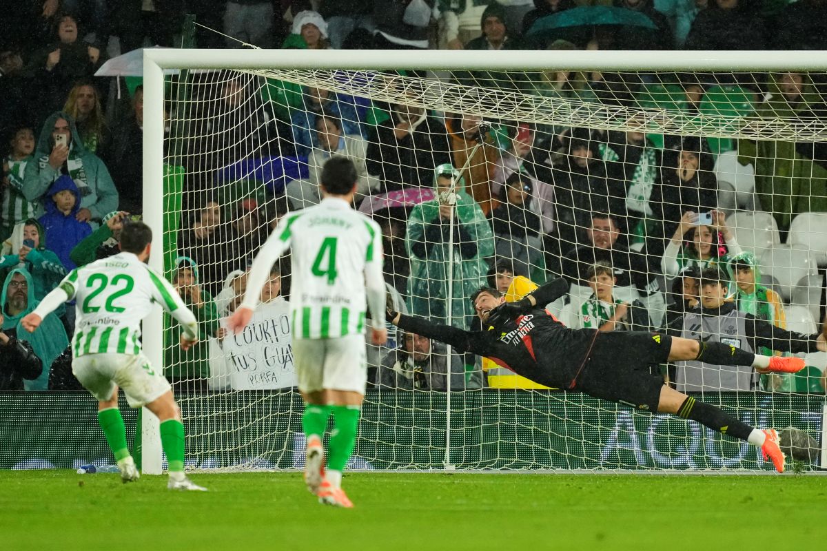 Real Madrid's goalkeeper Thibaut Courtois, right, fails to save the ball as Betis' Isco, left, scores his side's second goal during a Spanish La Liga soccer match between Real Betis and Real Madrid at the Benito Villamarin stadium in Seville, Spain, Saturday, March 1, 2025. (AP Photo/Jose Breton)