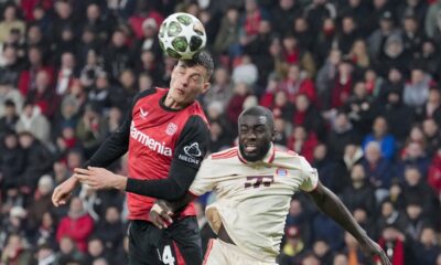 Leverkusen's Patrik Schick, left, jumps for the ball with Bayern's Dayot Upamecano during the Champions League round of 16 second leg soccer match between Bayer Leverkusen and Bayern Munich at the BayArena in Leverkusen, Germany, Tuesday, March 11, 2025. (AP Photo/Martin Meissner)