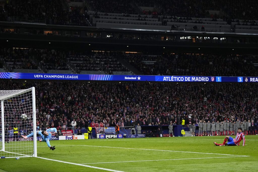 Atletico Madrid's Julian Alvarez falls to the ground after taking a penalty kick during a shootout at the end of the Champions League round of 16, second leg, soccer match between Atletico Madrid and Real Madrid at the Metropolitano stadium in Madrid, Spain, Wednesday, March 12, 2025. (AP Photo/Manu Fernandez)