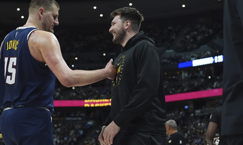 Denver Nuggets center Nikola Jokic, left, greets Los Angeles Lakers guard Luka Doncic, right, in the first half of an NBA basketball game Friday, March 14, 2025, in Denver. (AP Photo/David Zalubowski)