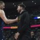 Denver Nuggets center Nikola Jokic, left, greets Los Angeles Lakers guard Luka Doncic, right, in the first half of an NBA basketball game Friday, March 14, 2025, in Denver. (AP Photo/David Zalubowski)