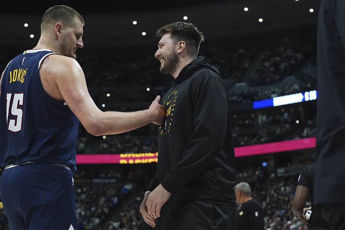 Denver Nuggets center Nikola Jokic, left, greets Los Angeles Lakers guard Luka Doncic, right, in the first half of an NBA basketball game Friday, March 14, 2025, in Denver. (AP Photo/David Zalubowski)