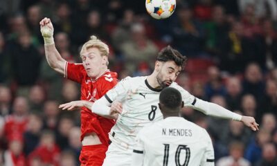 Denmark's Mika Biereth, left, and Portugals Bruno Fernandes vie for the ball during the Nations League playoff soccer match between Denmark and Portugal at Parken in Copenhagen, Thursday, March 20, 2024. (Liselotte Sabroe/Ritzau Scanpix via AP)