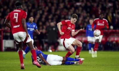 Ipswich Town's Ben Johnson, center, slides in on Nottingham Forest's Ryan Yates during the English FA Cup fifth soccer round match between Nottingham Forest and Ipswich Town at the City Ground, Nottingham, England, Monday, March 3, 2025. (Mike Egerton/PA via AP)