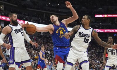 Denver Nuggets center Nikola Jokic, center, fights for control of a rebound between Sacramento Kings center Jonas Valanciunas, left, and forward DeMar DeRozan in the second half of an NBA basketball game Wednesday, March 5, 2025, in Denver. (AP Photo/David Zalubowski)