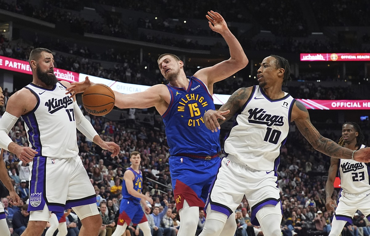 Denver Nuggets center Nikola Jokic, center, fights for control of a rebound between Sacramento Kings center Jonas Valanciunas, left, and forward DeMar DeRozan in the second half of an NBA basketball game Wednesday, March 5, 2025, in Denver. (AP Photo/David Zalubowski)