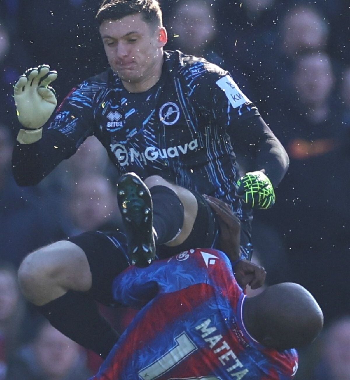 Crystal Palace's Jean-Philippe Mateta is fouled by Millwall goalkeeper Liam Roberts, for which he got a red card, during the English FA Cup soccer match between Crystal Palace and Millwall at Selhurst Park, London, England, Saturday, March 1, 2025. (AP Photo/Ian Walton)