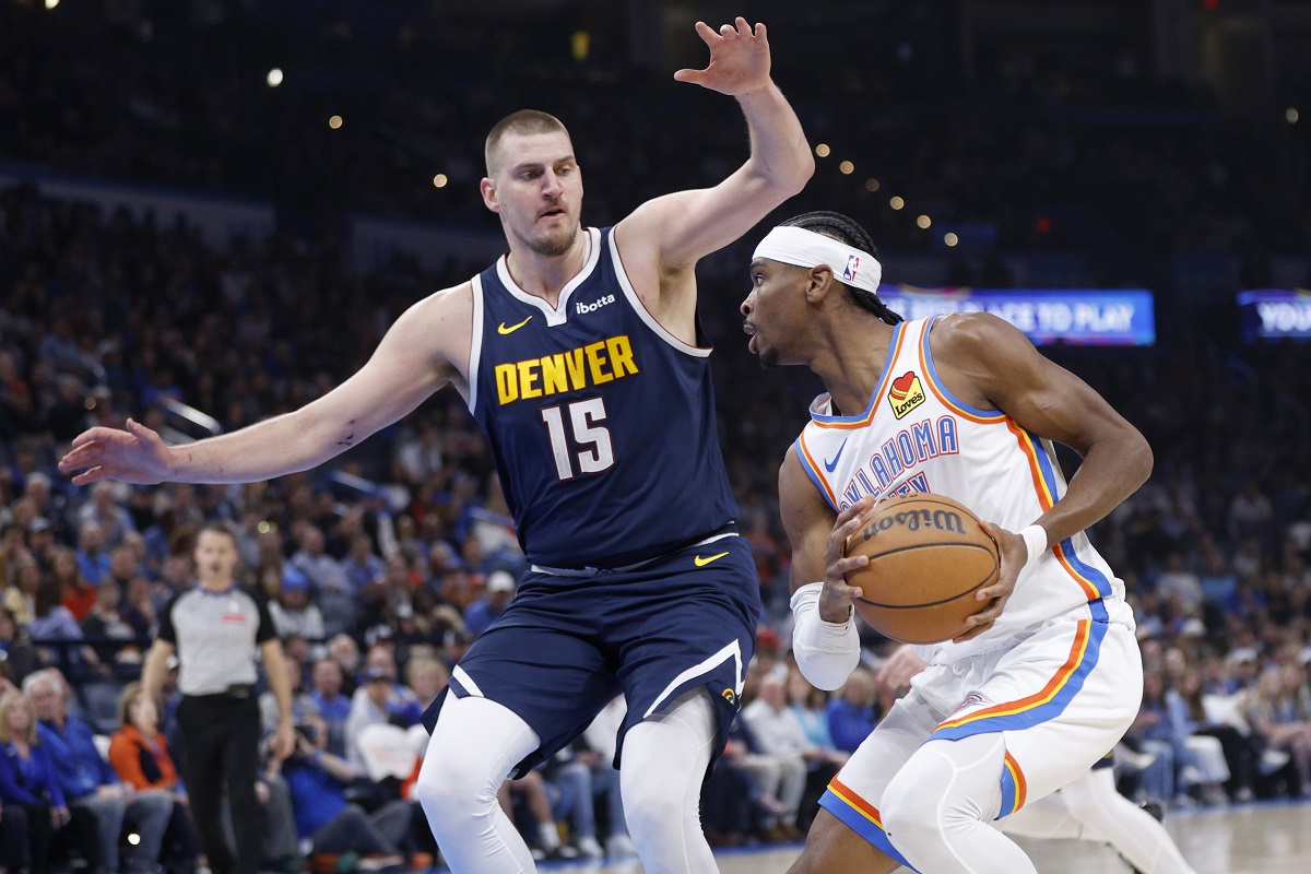 Oklahoma City Thunder guard Shai Gilgeous-Alexander, right, drives against Denver Nuggets center Nikola Jokic (15) during the first half of an NBA basketball game Monday, March 10, 2025, in Oklahoma City. (AP Photo/Nate Billings)