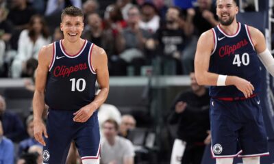 Los Angeles Clippers guard Bogdan Bogdanovic, left, and center Ivica Zubac smile after he scored during the second half of an NBA basketball game against the Houston Rockets, Wednesday, April 9, 2025, in Inglewood, Calif. (AP Photo/Mark J. Terrill)