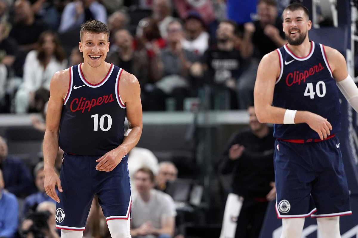 Los Angeles Clippers guard Bogdan Bogdanovic, left, and center Ivica Zubac smile after he scored during the second half of an NBA basketball game against the Houston Rockets, Wednesday, April 9, 2025, in Inglewood, Calif. (AP Photo/Mark J. Terrill)