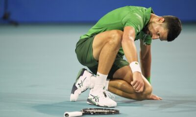 Novak Djokovic, of Serbia, gets up after collapsing on the court, as he plays Jakub Mensik, of Czech Republic, in the men's singles final match at the Miami Open tennis tournament, Sunday, March 30, 2025, in Miami Gardens, Fla. (AP Photo/Rebecca Blackwell)