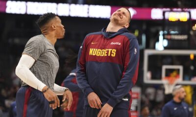 Denver Nuggets guard Russell Westbrook, left, jokes with center Nikola Jokic, right, before an NBA basketball game against the Memphis Grizzlies, Friday, April 11, 2025, in Denver. (AP Photo/David Zalubowski)