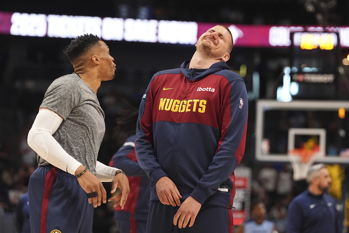 Denver Nuggets guard Russell Westbrook, left, jokes with center Nikola Jokic, right, before an NBA basketball game against the Memphis Grizzlies, Friday, April 11, 2025, in Denver. (AP Photo/David Zalubowski)