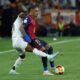 Barcelona's Raphinha, right, is challenged by Real Madrid's Rodrygo during the Spanish Copa del Rey final soccer match between Barcelona and Real Madrid at Estadio de La Cartuja stadium in Seville, Spain, Saturday, April 26, 2025. (AP Photo/Joan Monfort)