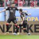 Berlin's Andrej Ilic, left, and Berlin's Josip Juranovic after scoring their side's second goal during the German Bundesliga soccer match between SC Freiburg - 1. FC Union Berlin at The Europa-Park Stadion in Freiburg, Germany, Sunday, March 30, 2025. (Harry Langer/dpa via AP)