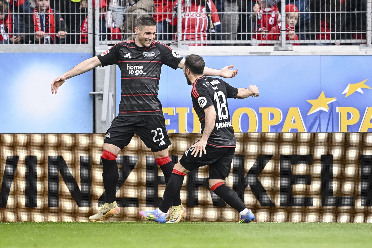 Berlin's Andrej Ilic, left, and Berlin's Josip Juranovic after scoring their side's second goal during the German Bundesliga soccer match between SC Freiburg - 1. FC Union Berlin at The Europa-Park Stadion in Freiburg, Germany, Sunday, March 30, 2025. (Harry Langer/dpa via AP)