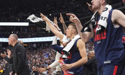 Los Angeles Clippers guard Bogdan Bogdanovic, center, joins teammates in celebrating after a 3-point basket by guard Norman Powell in the second half of Game 2 of a first-round NBA playoff series against the Denver Nuggets, Monday, April 21, 2025, in Denver. (AP Photo/David Zalubowski)