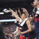 Los Angeles Clippers guard Bogdan Bogdanovic, center, joins teammates in celebrating after a 3-point basket by guard Norman Powell in the second half of Game 2 of a first-round NBA playoff series against the Denver Nuggets, Monday, April 21, 2025, in Denver. (AP Photo/David Zalubowski)