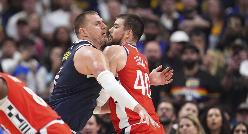 Denver Nuggets center Nikola Jokic, left, moves past Los Angeles Clippers center Ivica Zubac in the second half of Game 2 of a first-round NBA playoff series Monday, April 21, 2025, in Denver. (AP Photo/David Zalubowski)