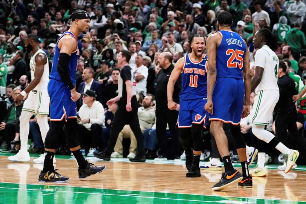 Knicks Celtics Basketball New York Knicks guard Jalen Brunson (11) celebrates after a win with teammates as Boston Celtics' Jrue Holiday, right, and Jaylen Brown, back left, walk off the court following Game 1 of an NBA basketball second-round playoff series Monday, May 5, 2025, in Boston. (AP Photo/Charles Krupa)