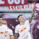 Leipzig's Benjamin Sesko, right, celebrates after scoring his side's opening goal during the German Bundesliga soccer match between RB Leipzig and FC Bayern Munich at the Red Bull Arena in Leipzig, Germany, Saturday, May 3, 2025. (AP Photo/Ebrahim Noroozi)