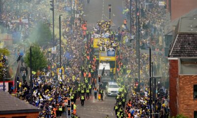 Fans line the street as the Leeds United parade buses enter the city centre during the English Football League Championship trophy parade in Leeds, England, Monday May 5, 2025. (Danny Lawson/PA via AP)