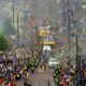 Fans line the street as the Leeds United parade buses enter the city centre during the English Football League Championship trophy parade in Leeds, England, Monday May 5, 2025. (Danny Lawson/PA via AP)