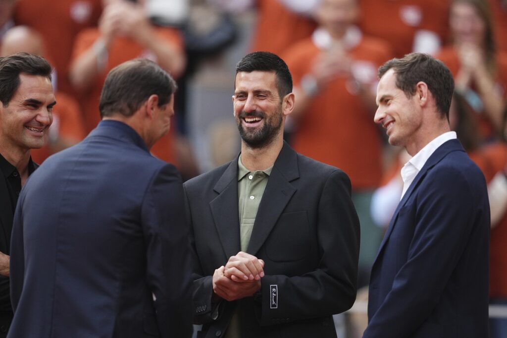 Rafa Nadal, second from left, is joined by Roger Federer, left, Novak Djokovic and Andy Murray, right, during a farewell ceremony at center court Philippe-Chatrier, at the Roland-Garros stadium, in Paris, Sunday May 25, 2025. (AP Photo/Lindsey Wasson)