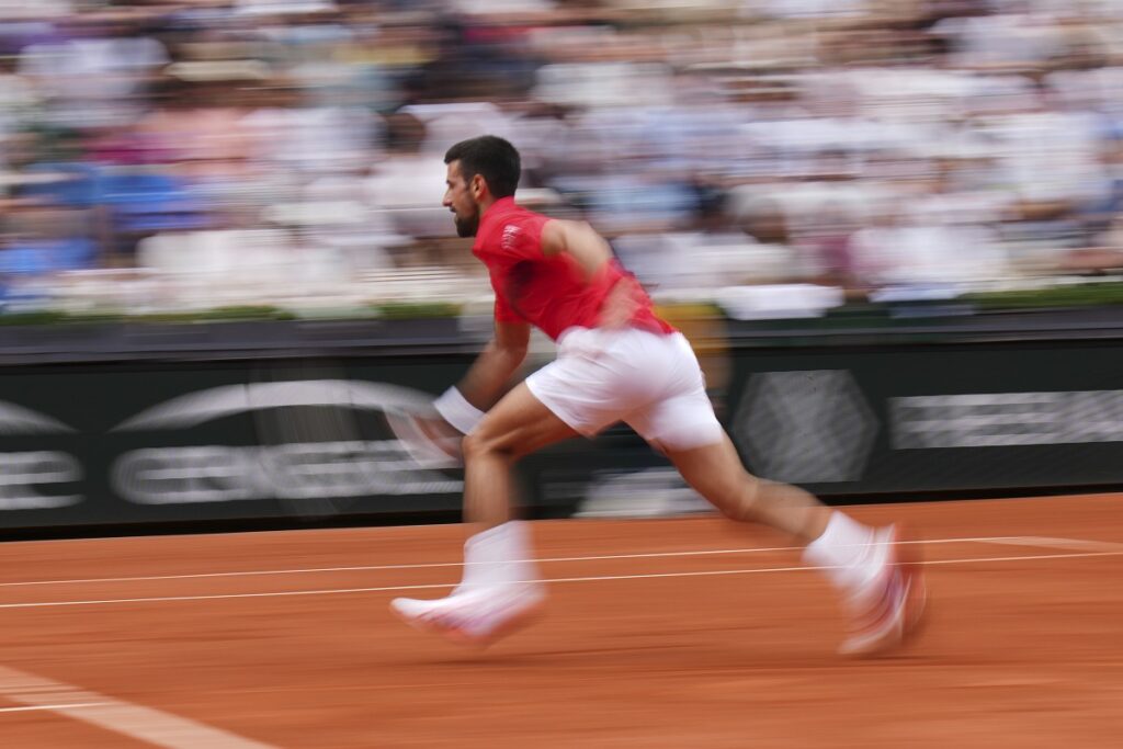 Serbia's Novak Djokovic returns the ball to France's Corentin Moutet during their second round match of the French Tennis Open, at the Roland-Garros stadium, in Paris, Thursday, May 29, 2025. (AP Photo/Christophe Ena)