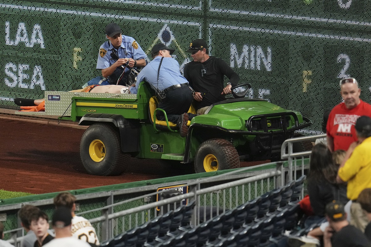A fan is carted off the field at PNC Park after falling out of the stands during the seventh inning of a baseball game between the Pittsburgh Pirates and the Chicago Cubs in Pittsburgh, Wednesday, April 30, 2025. (AP Photo/Gene J. Puskar)