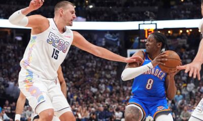 Oklahoma City Thunder forward Jalen Williams, right, looks to pass the ball as Denver Nuggets center Nikola Jokic defends in the second half of Game 6 in the Western Conference semifinals of the NBA basketball playoffs Thursday, May 15, 2025, in Denver. (AP Photo/David Zalubowski)