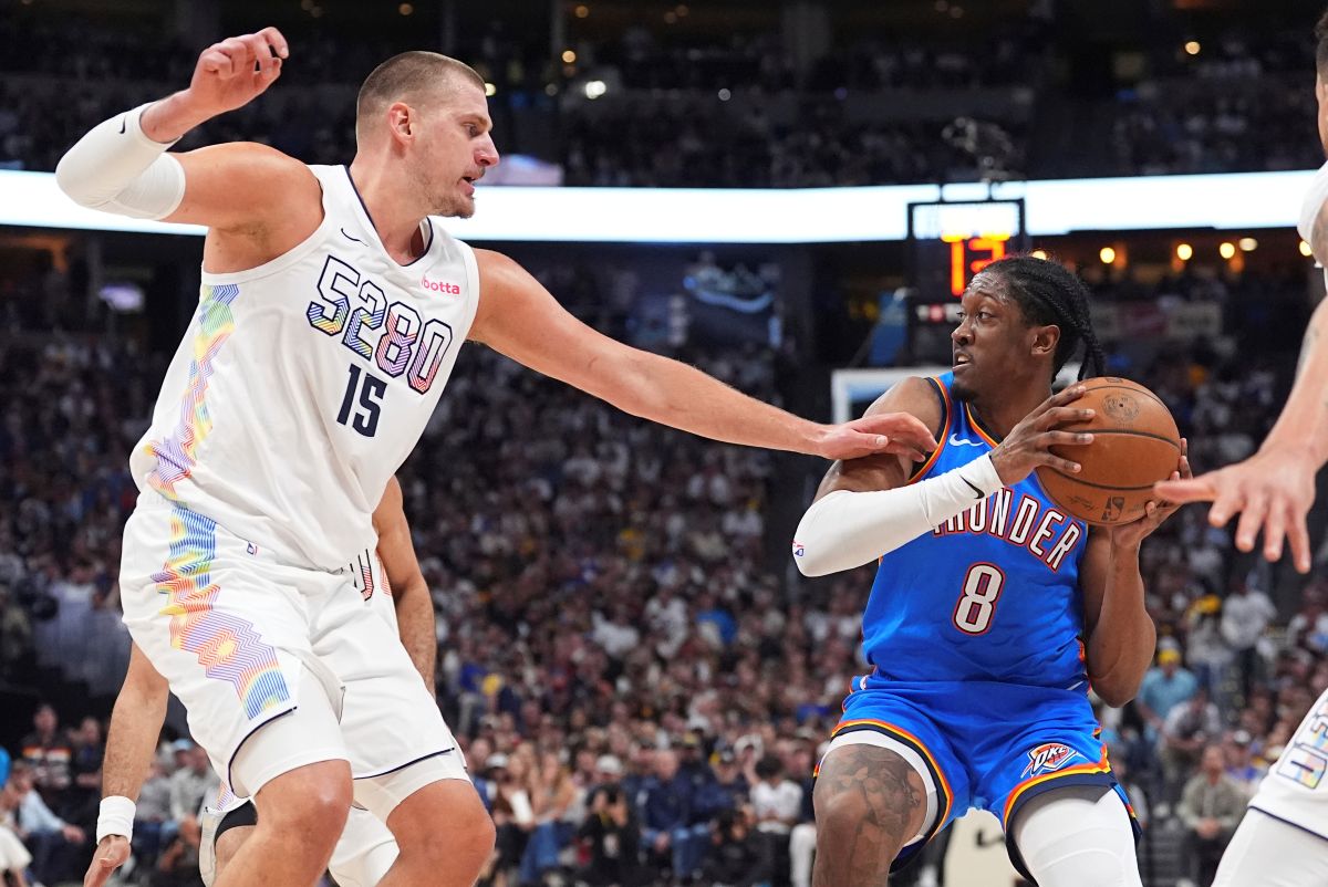 Oklahoma City Thunder forward Jalen Williams, right, looks to pass the ball as Denver Nuggets center Nikola Jokic defends in the second half of Game 6 in the Western Conference semifinals of the NBA basketball playoffs Thursday, May 15, 2025, in Denver. (AP Photo/David Zalubowski)